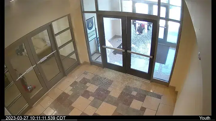 Covenant School Shooter Audrey Hale Is Seen On Surveillance Footage Climbing Through The School'S Glass Doors After Shooting Through Them