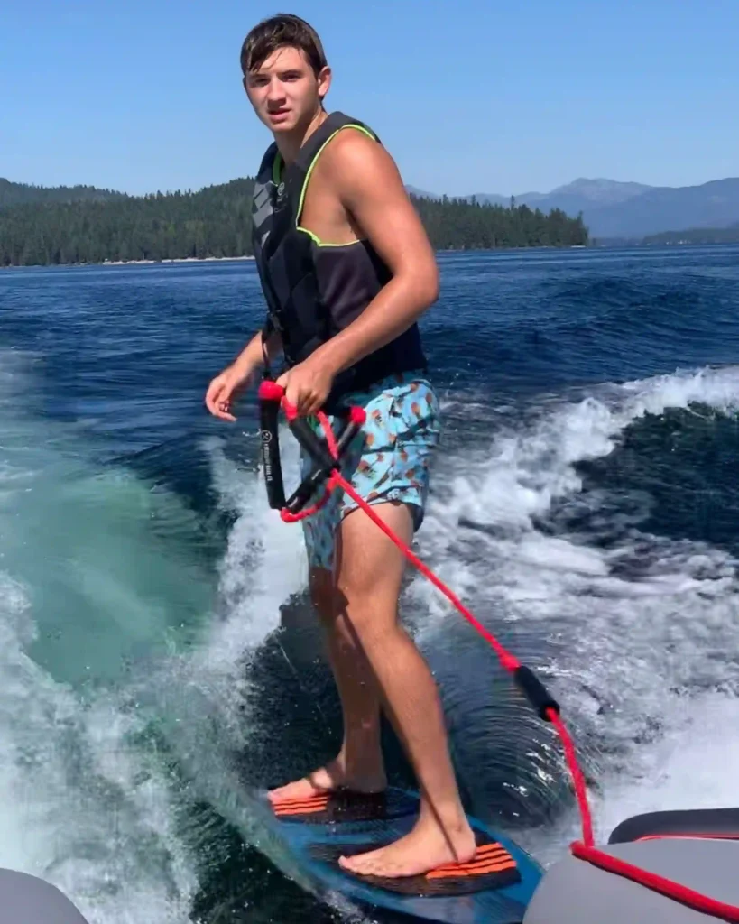 Ethan Chapin surfs on Priest Lake in northern Idaho in this family photo from July 2022. Chapin was one of four University of Idaho students found stabbed to death in a home near the Moscow, Idaho campus on Nov. 13, 2022.