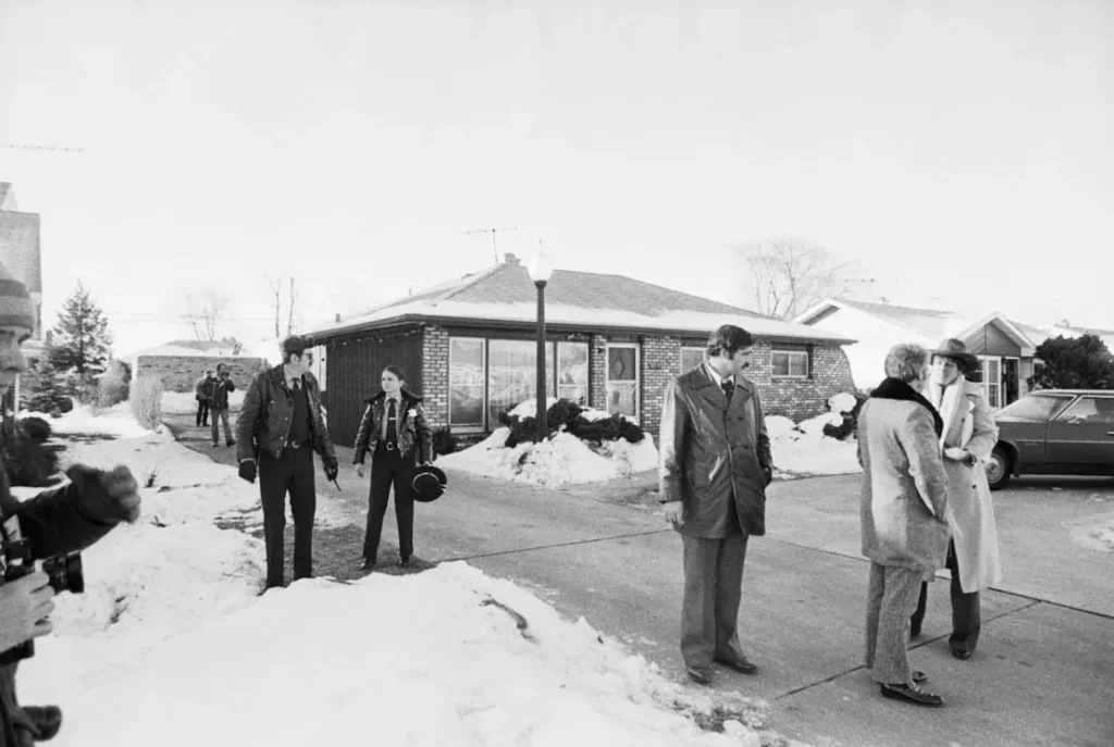 Police are seen on December 22, 1978, surrounding the home of the serial killer John Wayne Gacy, where the bodies of a number of his victims were found.