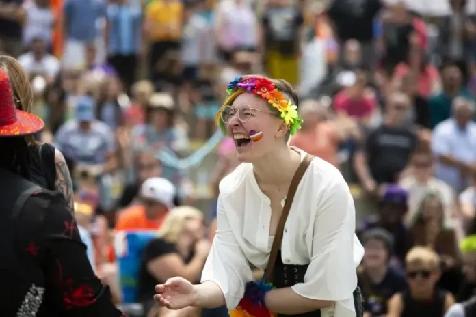 A Grand Haven Pride Fest attendee is seen cheering during a drag show at the Lynne Sherwood Waterfront Stadium in Grand Haven, Mich., on Saturday, June 10, 2023.